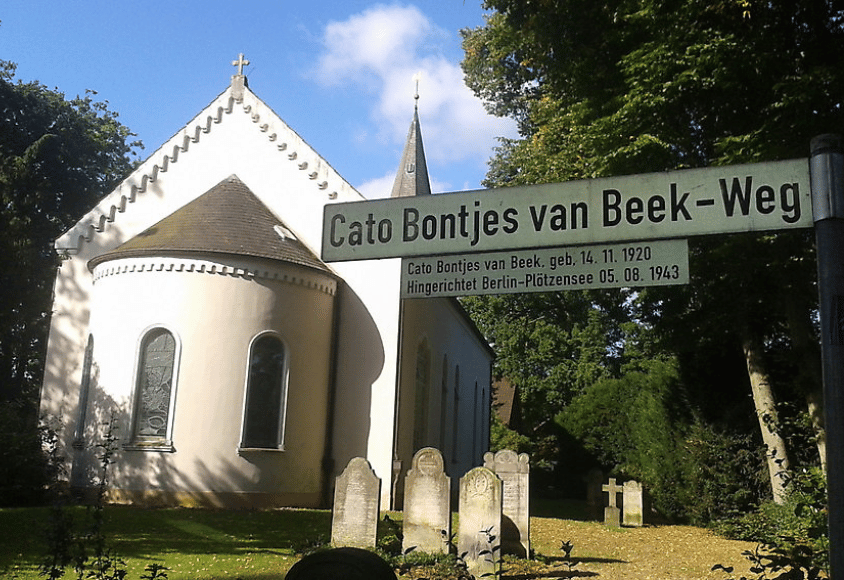 Schild mit der Aufschrift "Cato Bontjes van Beek-Weg" neben einer Kapelle.
