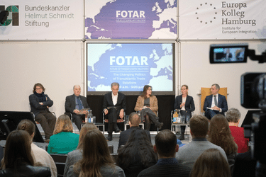 Photo of six people sitting and debating on the stage at the FOTAR conference.