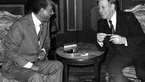Helmut Schmidt and Anwar as-Sadat laughing in conversation