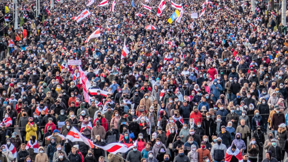 Crowd at demonstration with numerous white-red-white flags