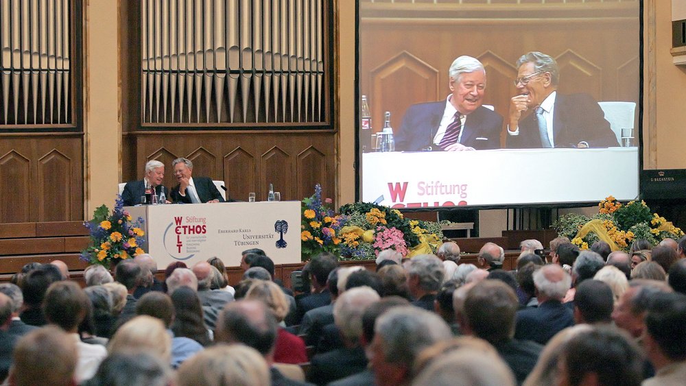 Helmut Schmidt and Hans Küng together on the podium in front of an audience