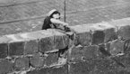 Black-and-white photograph of construction workers building the Wall