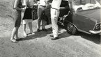 Black and white shot of Loki and Helmut Schmidt with two other people standing in front of a car