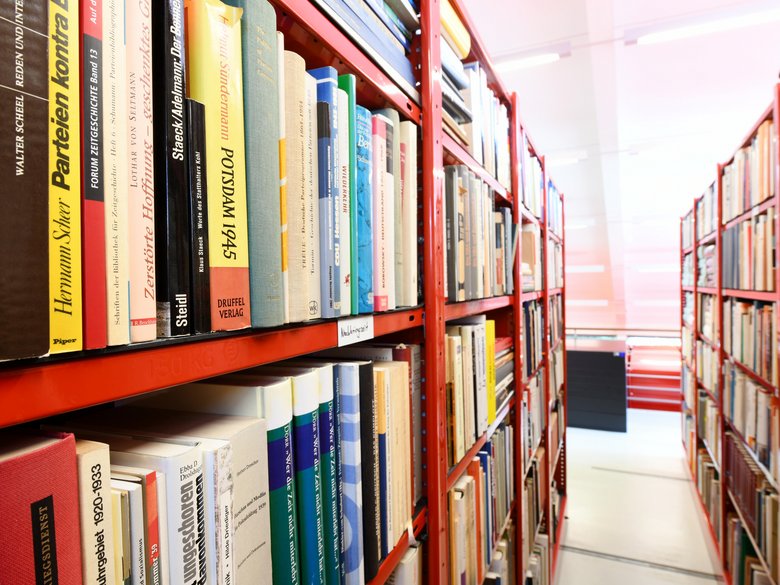 Row of red shelves with books