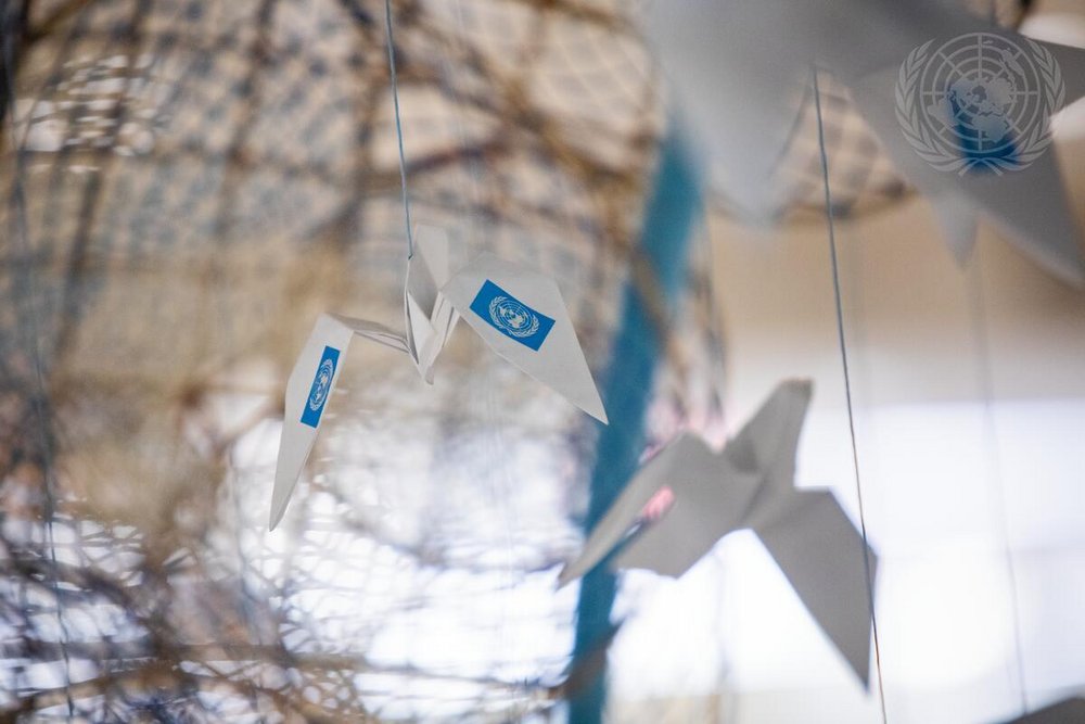 Photo of a paper aeroplane with the logo of the United Nations