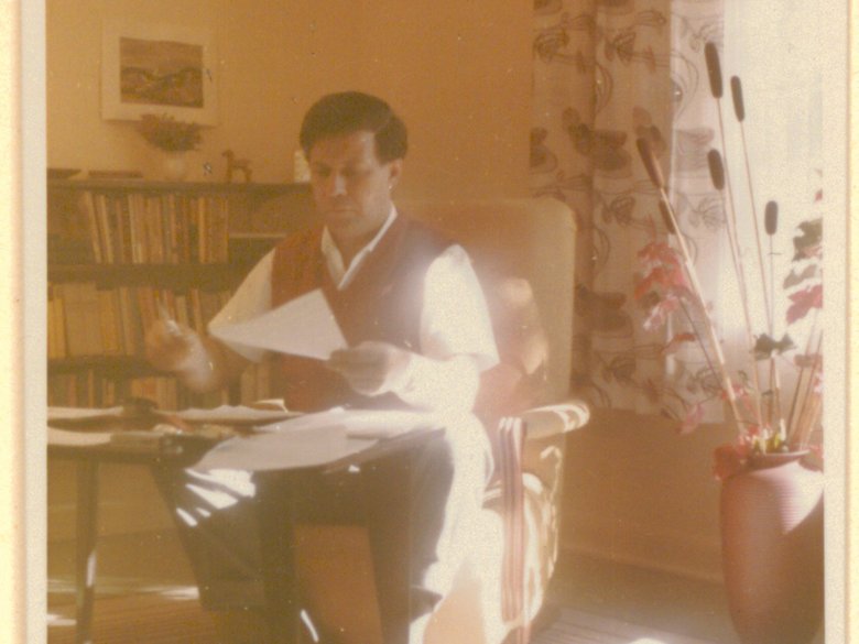 Photograph of Helmut Schmidt at desk with paper in hand 