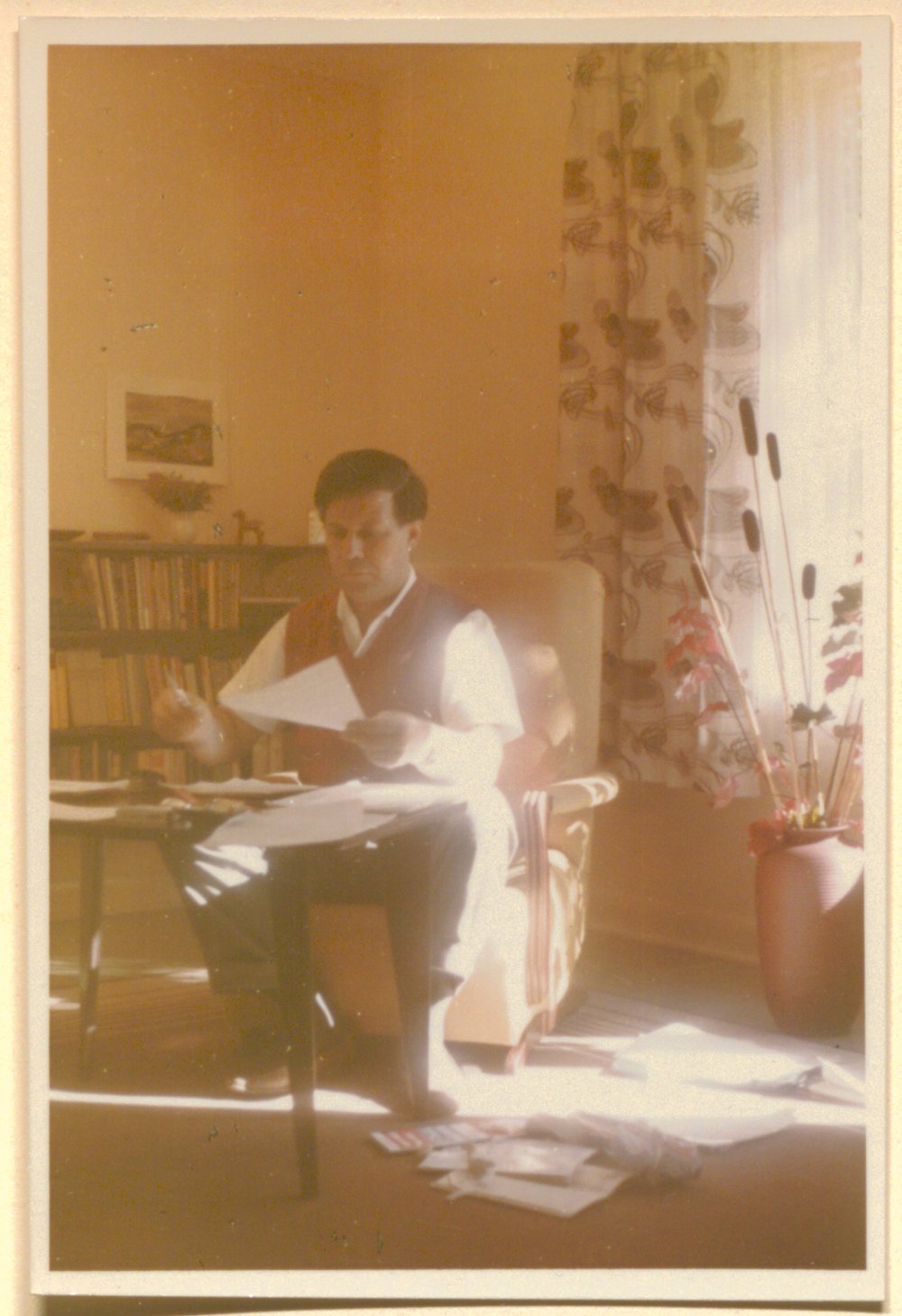 Helmut Schmidt sitting at a desk with paper in his hand