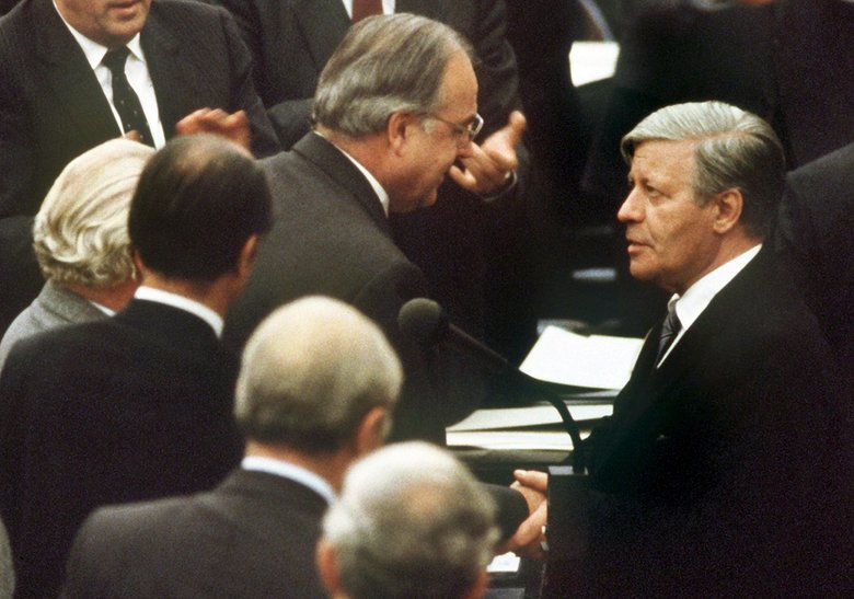 On 1 October 1982, the ousted Chancellor Helmut Schmidt (right, SPD) congratulates his successor Helmut Kohl (centre) on his election.