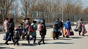 Ukrainian refugees with suitcases and rucksacks
