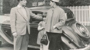 Black and white photograph of the Schmidt family in front of a car