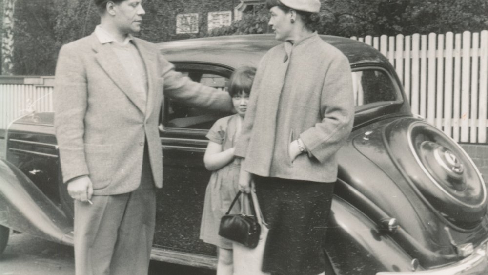 Black and white photograph of the Schmidt family in front of a car