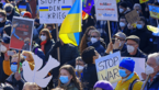 Crowd of demonstrators with Ukraine flags and signs