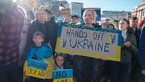 Demonstrators with Ukrainian flags and anti-war demonstration signs 