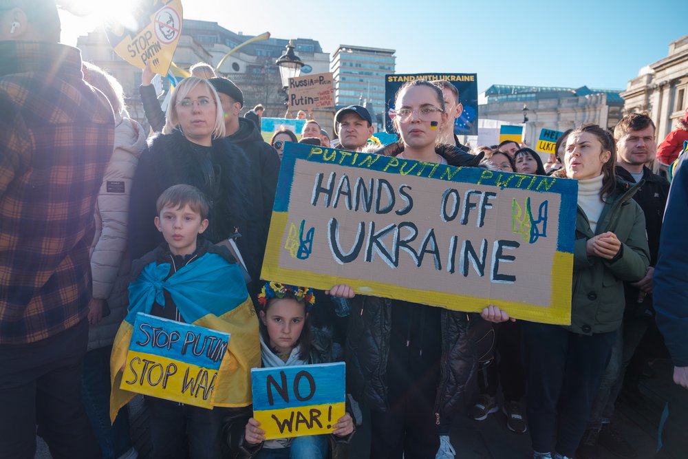 Demonstrators with Ukraine flags and anti-war demonstration signs