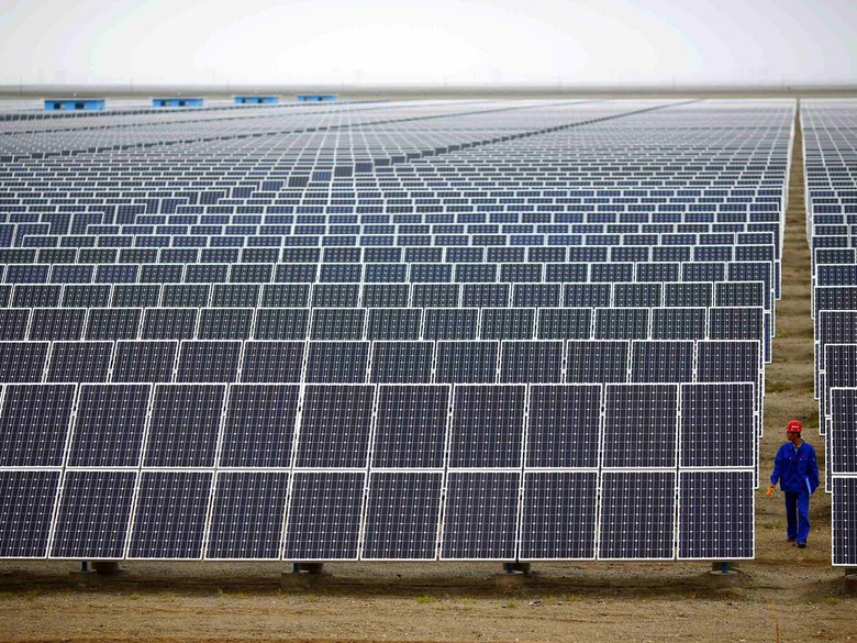 A worker checks solar modules at a solar park in Dunhuang, around 950 kilometres northwest of Lanzhou in Gansu province.