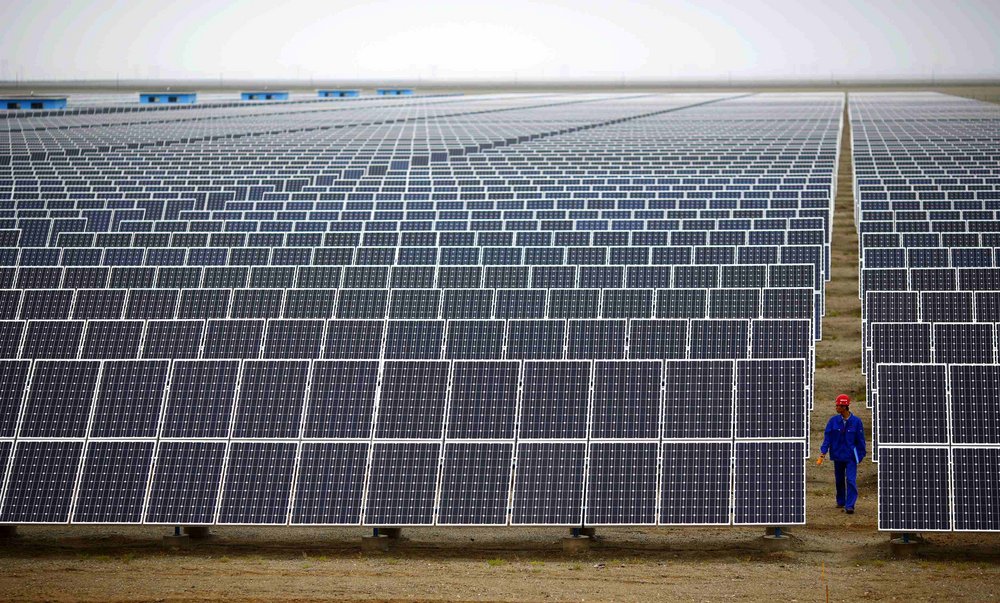 A worker checks solar modules at a solar park in Dunhuang, around 950 kilometres northwest of Lanzhou in Gansu province.