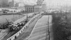 Bird's-eye view of the construction of the Wall in black and white, with the Brandenburg Gate in the background