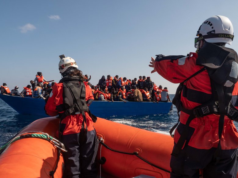 Rescue team and refugee boat