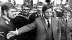 Black and white photograph of Helmut Schmidt in front of soldiers of the air force, navy and army