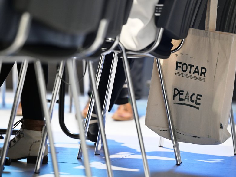 Colour photograph: chairs; a linen bag bearing the inscription ‘FOTAR’ is hanging from one of the chairs