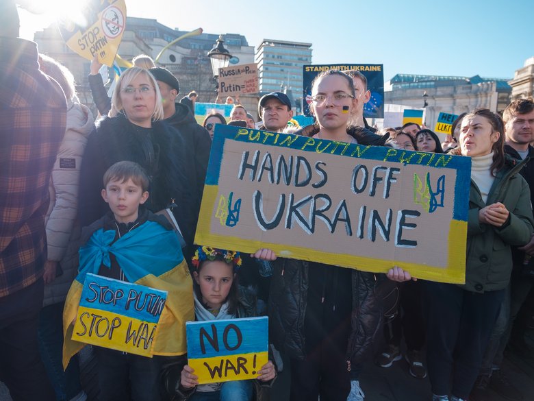 Demonstrators with Ukraine flags and anti-war demonstration signs