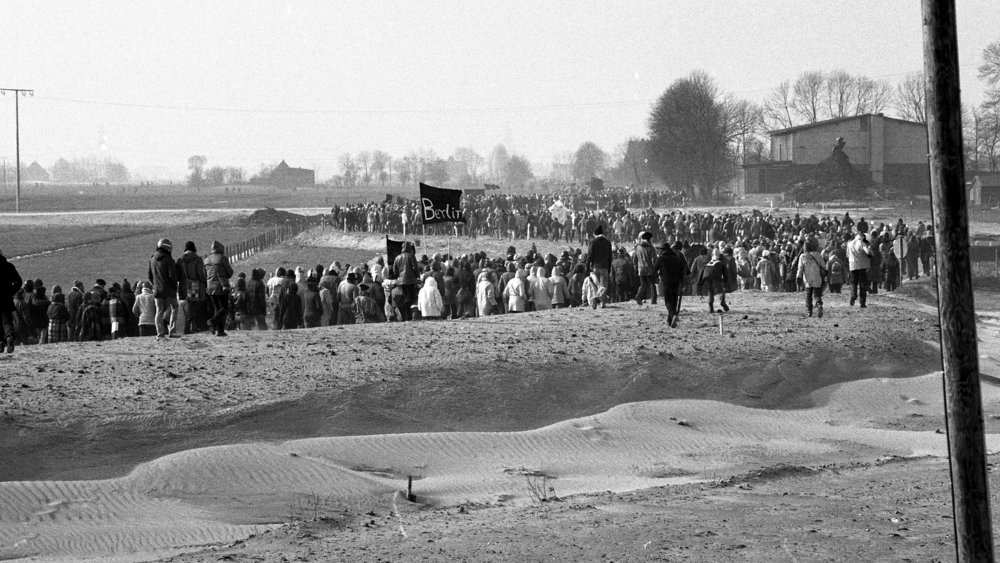 Black and white photograph of long procession of demonstrators 