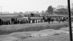 Black and white photograph of long procession of demonstrators 