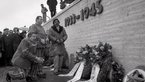Activists and survivors of the Nazi genocide in front of the memorial wall at the Dachau Concentration Camp Memorial Site